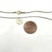 ohm disc string neck coin